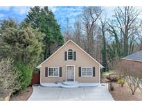 A charming tan house with a gray roof and dark shutters at 2843 Merritt Dr, Buford, GA 30518