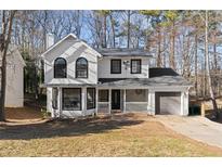 Two-story house with a gray roof and attached garage at 1126 Williamsburg Ln, Norcross, GA 30093