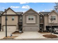 Modern taupe townhome with two-car garage and landscaping at 360 Rockfern Ct, Lilburn, GA 30047