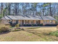 Brick ranch house with covered porch and landscaped yard at 4392 Huntington Cir, Atlanta, GA 30338