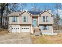 Two-story house with gray siding, teal shutters, and a two-car garage at 966 Mary Frances Ct, Dacula, GA 30019