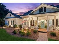Charming white home with inviting porch and manicured front yard landscaping at 101 Barker Rd, Cumming, GA 30040
