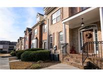 Brick townhouses with lush landscaping and inviting front porches at 342 Holbrook Rd, Smyrna, GA 30082