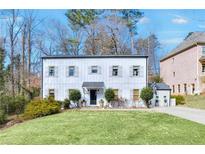 Charming two-story home with white siding and manicured lawn at 4290 Valley Trail Se Dr, Atlanta, GA 30339