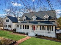 Charming two-story white home with a welcoming front porch and well-manicured lawn at 5422 Hill Sw Rd, Powder Springs, GA 30127