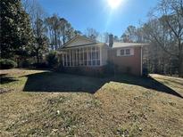 Brick ranch house with screened porch and large yard at 5670 Lanny Dr, Powder Springs, GA 30127