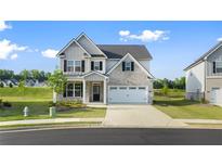 Charming two-story home with a mix of stone and siding, complemented by a well-manicured lawn at 13550 Whitman Se Ln, Covington, GA 30014