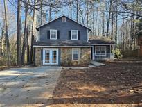 Gray house with stone accents and a spacious yard at 1037 Forest Path, Stone Mountain, GA 30088