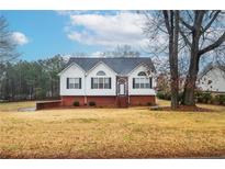 Brick and white ranch home with attached garage and landscaped yard at 2832 Fieldstone Se Dr, Conyers, GA 30013