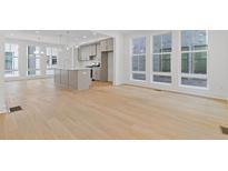 Bright open concept living room and kitchen area featuring a kitchen island and large windows at 1767 Beckham Ne Pl # 54, Atlanta, GA 30324