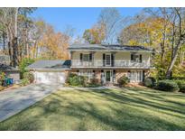 Brick two-story house with a large front yard and attached garage at 1883 Acuba Ln, Atlanta, GA 30345