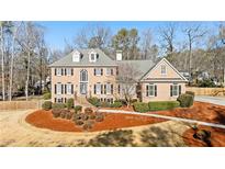 Brick house with landscaped yard and large driveway at 2085 Innsfail Dr, Snellville, GA 30078