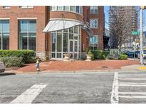 Inviting building entrance with red brick, modern awnings, and well-maintained landscaping at 325 E Paces Ferry Rd # 2003, Atlanta, GA 30305