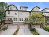 Three-story townhome with attached garages and a charming front facade at 3200 Saute Way, Avondale Estates, GA 30002