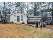 Tan house with blue door, deck, and landscaped yard at 3743 Turner Heights Dr, Decatur, GA 30032