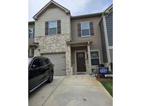 Charming two-story townhome features a brick and siding facade with a convenient attached garage at 2502 Polaris Sw Way, Atlanta, GA 30331