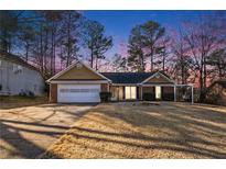 Ranch style home with attached garage and landscaped yard at 5659 Rex Mill Crk, Rex, GA 30273