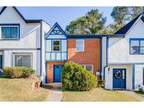 Brick front townhouse with blue door and landscaping at 3614 Main Station Sw Dr, Marietta, GA 30008