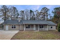 Ranch style home with front porch and large backyard at 165 Riverbend Dr, Covington, GA 30014