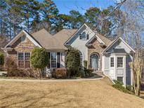 Stunning two-story home with stone accents and manicured lawn at 2311 Shoreline Pkwy, Villa Rica, GA 30180