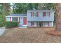 Gray siding two-story house with red shutters and a red front door at 2036 Countydown Ln, Stone Mountain, GA 30088