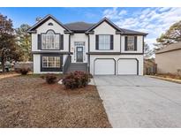 Two-story house with white siding, gray accents, and a two-car garage at 2718 Beaver Creek Xing, Powder Springs, GA 30127