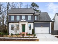 Two-story house featuring gray siding, white accents, and a green front door at 386 10Th Unit 57 St, Auburn, GA 30011