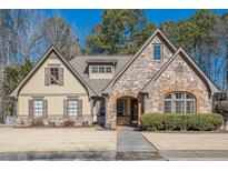 Curb appeal abounds at this charming two-story home showcasing stone accents and a manicured lawn at 4824 Archer Pl, Acworth, GA 30101