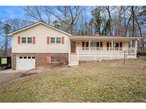 Ranch house with brick and siding, covered porch, and attached garage at 1836 Poinsetta Dr, Acworth, GA 30102