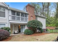 Attractive exterior of condo with private patio and wooded views at 1379 Keys Lake Ne Dr, Brookhaven, GA 30319