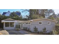 Gray brick ranch home with screened porch and landscaped yard at 2301 Drew Valley Ne Rd, Brookhaven, GA 30319