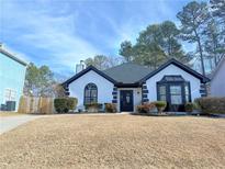 Charming one-story house with a white exterior, black accents, and manicured lawn at 2270 Waterford Park Dr, Lawrenceville, GA 30044