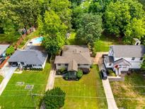 Charming home with a spacious yard, mature trees, and inviting pool, perfect for outdoor enjoyment at 1770 Rockland Se Dr, Atlanta, GA 30316