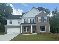 Beautiful new two-story home featuring brick and siding exterior, a two-car garage, and a well-maintained lawn at 5270 Birch Valley Rd, Cumming, GA 30028