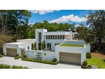 Modern white house with two garages and a green roof at 3770 Peachtree Ne Rd, Atlanta, GA 30319