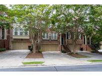 Brick townhome with two-car garage and lush landscaping at 2858 Overlook Trce, Atlanta, GA 30324