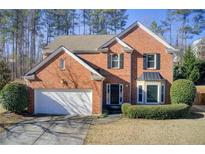 Two-story brick home with a white garage door and landscaping at 331 Ivy Manor Nw Dr, Marietta, GA 30064