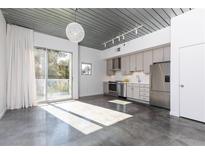 Bright, open living space with modern kitchen, polished concrete floors, and lots of natural light at 620 Glen Iris Ne Dr # 318, Atlanta, GA 30308