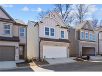 Two-story home with gray siding, stone accents, and a two-car garage at 714 Smokey Quartz Way, Kennesaw, GA 30144