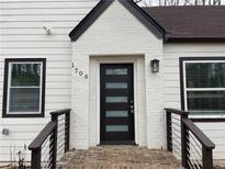 A beautifully designed home with black trim, a white brick facade, and a modern black front door at 1706 Alvarado Sw Ter, Atlanta, GA 30310