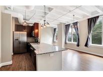 Modern kitchen with island and stainless steel appliances at 32 Peachtree Nw St # 308, Atlanta, GA 30303