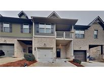 Brick front exterior of charming townhome with attached garage at 125 White Mountain Pass, Mcdonough, GA 30252