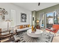 Bright living room with hardwood floors, modern decor, large windows, and a sliding glass door at 2199 Lenox Ne Rd # 13, Atlanta, GA 30324