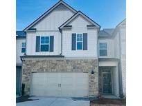 Charming two-story townhome with a stone facade and a two-car garage at 2458 Bayberry St, Acworth, GA 30101