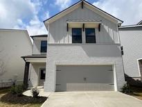 Charming two-story home with a brick facade and a spacious attached two-car garage at 4361 Portsbrook Ave, Snellville, GA 30039
