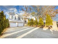 Beautiful home featuring a two-car garage, manicured landscaping, and a long driveway at 571 Oak Vista Ct, Lawrenceville, GA 30044
