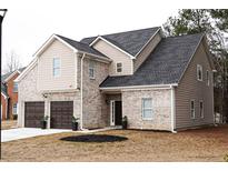 Two-story house with brick and siding, two-car garage, and landscaping at 3405 Summer Brooke Way, Union City, GA 30291