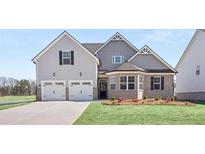 Two-story house with gray siding, white trim, and a two-car garage at 13547 Whitman Ln, Covington, GA 30014