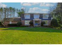 Two-story home with brick and blue siding, large windows, and a well-manicured lawn at 555 Hembree Rd, Roswell, GA 30076