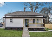 Charming white cottage with a black trim, landscaped yard, and a porch at 1617 Church Ne St, Conyers, GA 30012